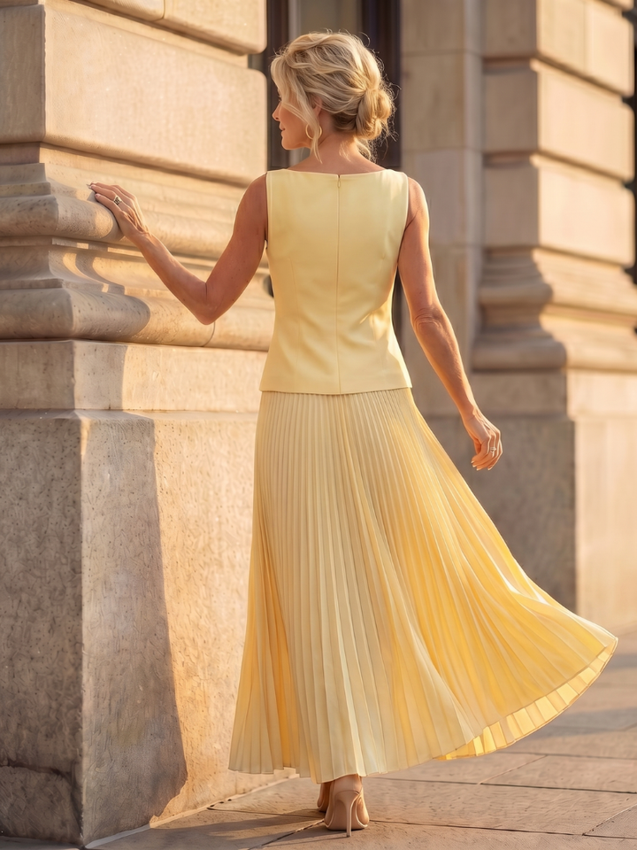 Versatile women's elegant outfit with a structured bodice top and a beautiful pleated maxi skirt.