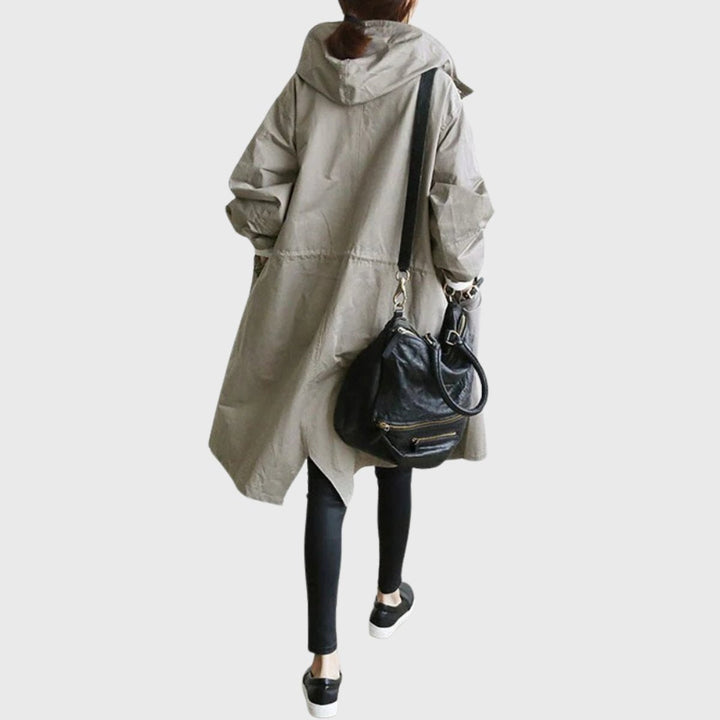 Modern women's hooded trench coat, long & water-resistant for a chic, relaxed fit in spring and fall.