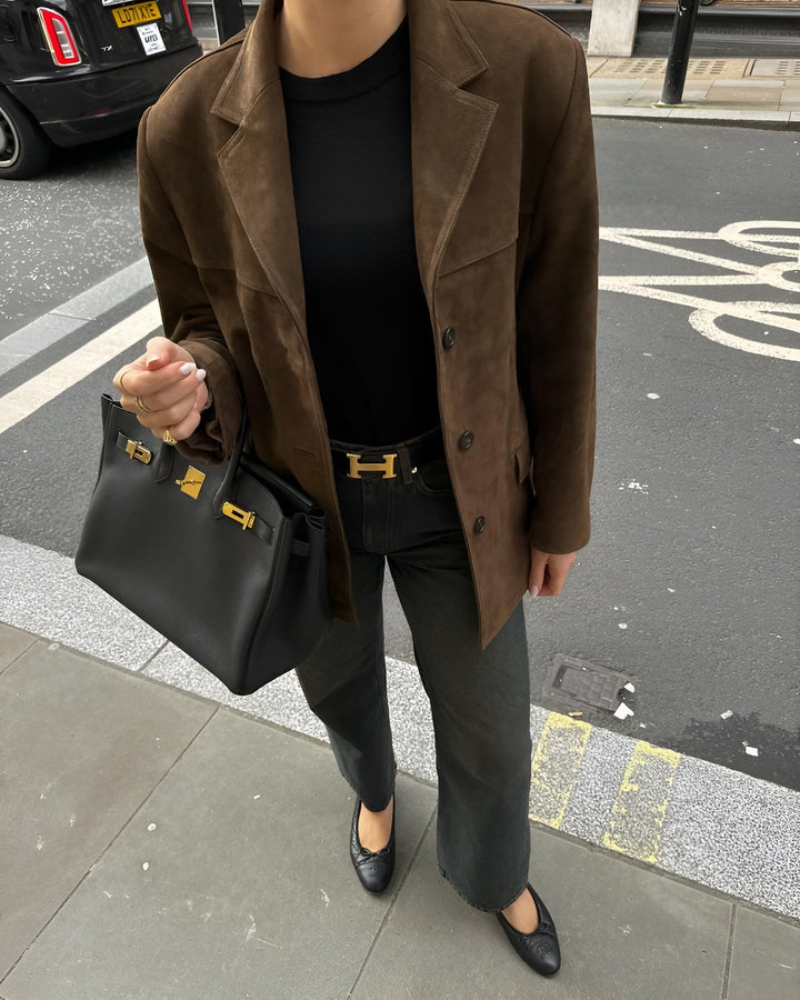 Polished women's one-button jacket, a must-have for versatile style and layering.