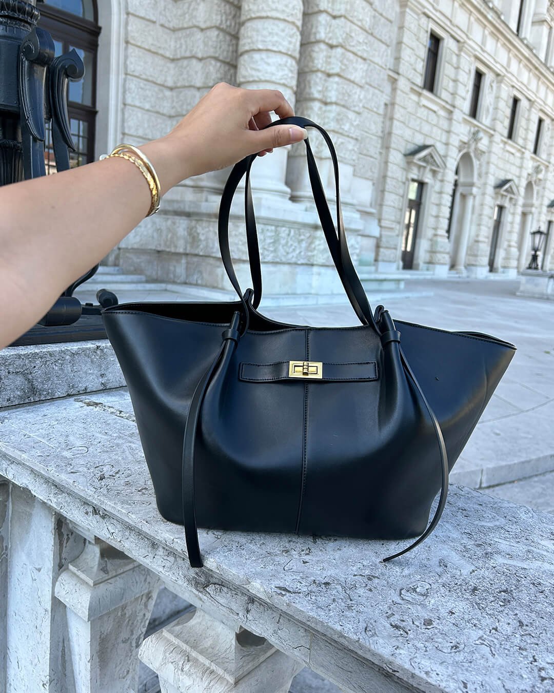 Stylish woman wearing the Verona Structured Shoulder Bag, perfect for an organized everyday look.