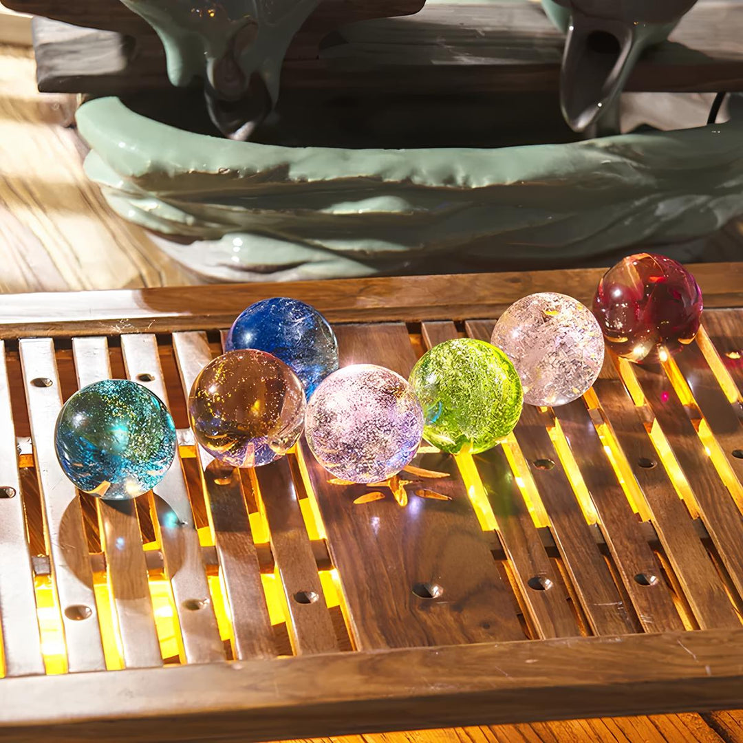 Captivating crystal galaxy orb with glowing wooden LED base, an enchanting celestial display light.