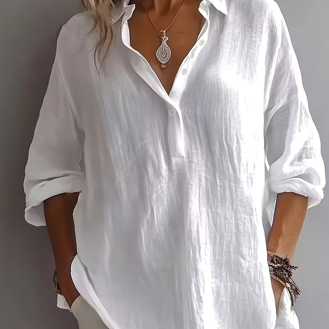 Women's relaxed fit button-up blouse. Comfortable long sleeve collared shirt for effortless style.