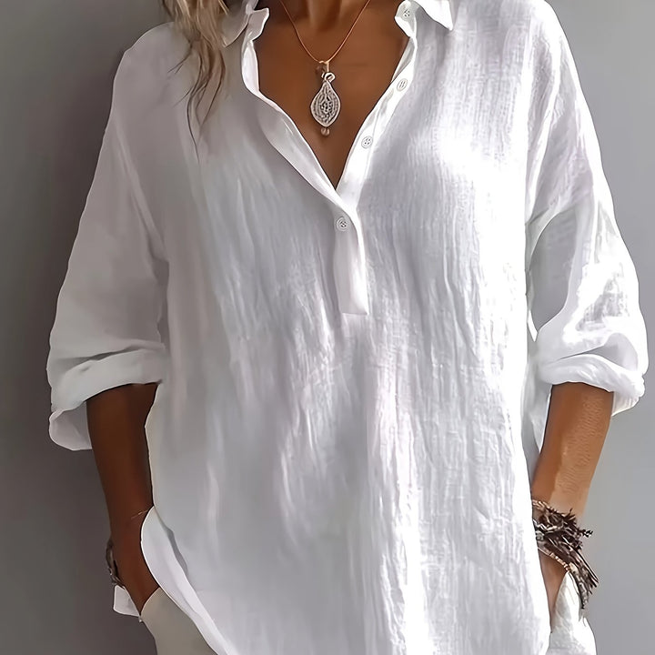 Women's relaxed fit button-up blouse. Comfortable long sleeve collared shirt for effortless style.