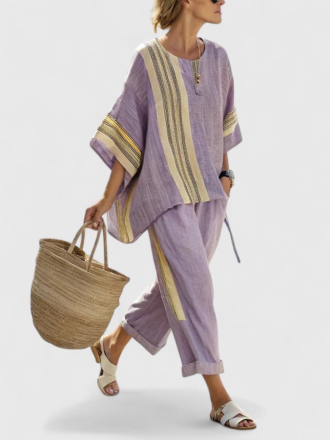 Women's oversized two-piece set with wide-leg pants & an asymmetrical top for a relaxed, stylish summer look.