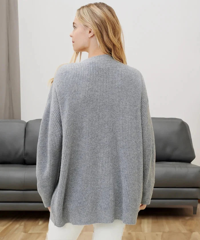 Close-up of the soft knit fabric and buttons on the women's black cardigan vest.