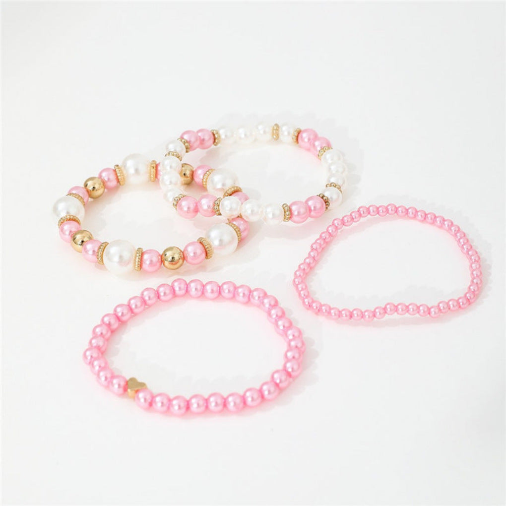 Stylish 4-piece women's bracelet set with faux pearls, heart beads. White layered fashion jewelry accessory.