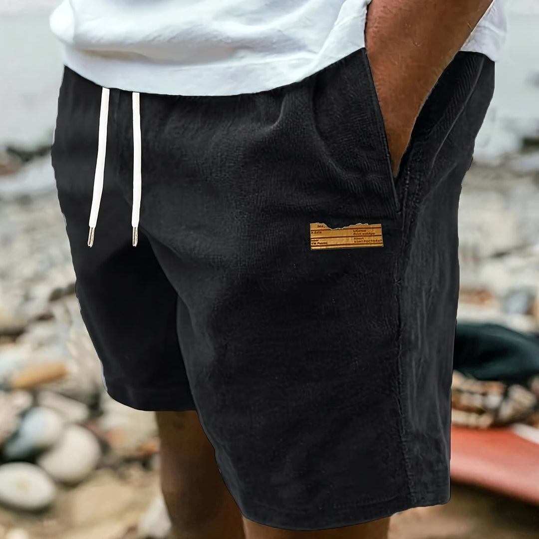 Back view of dark gray men's relaxed fit drawstring shorts, simple and casual style.