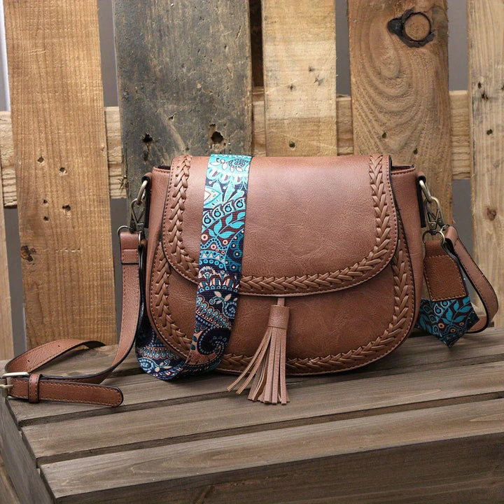 Versatile women's faux leather shoulder & crossbody bag with an elegant tassel detail.