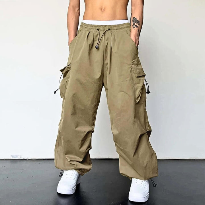 Unisex relaxed fit cargo joggers in black polyester, ultimate comfort for casual and streetwear style.
