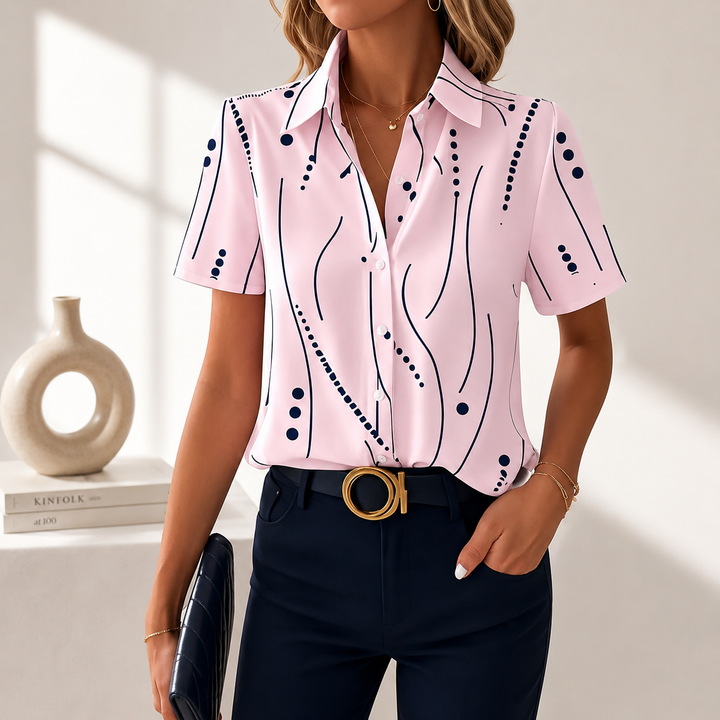 Close-up of elegant women's abstract print blouse fabric and button-front detail for sophisticated look.