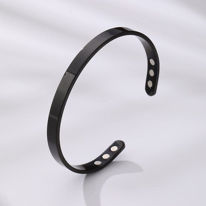 Durable wide glossy stainless steel magnetic cuff bracelet. Modern unisex fashion accessory.