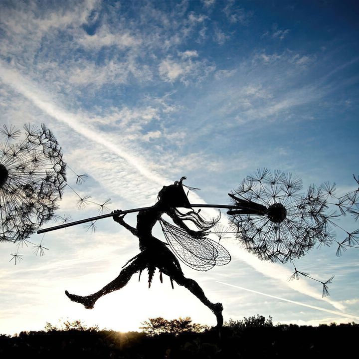 Decorative metal fairy stake for garden decor. Whimsical yard ornament adds a touch of magic to outdoor spaces.