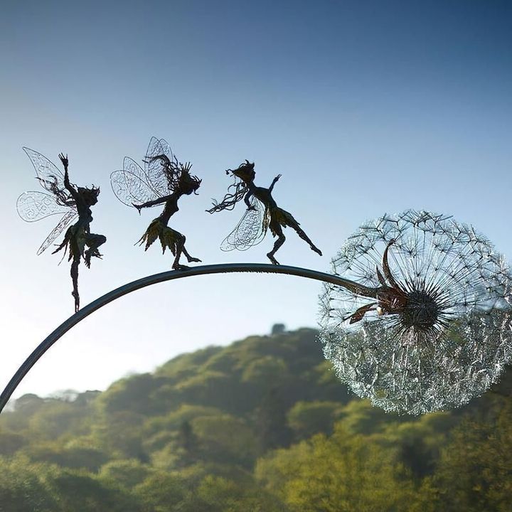 Elegant metal fairy garden stake, a stunning outdoor decoration & handmade landscape sculpture for enchanted yards.