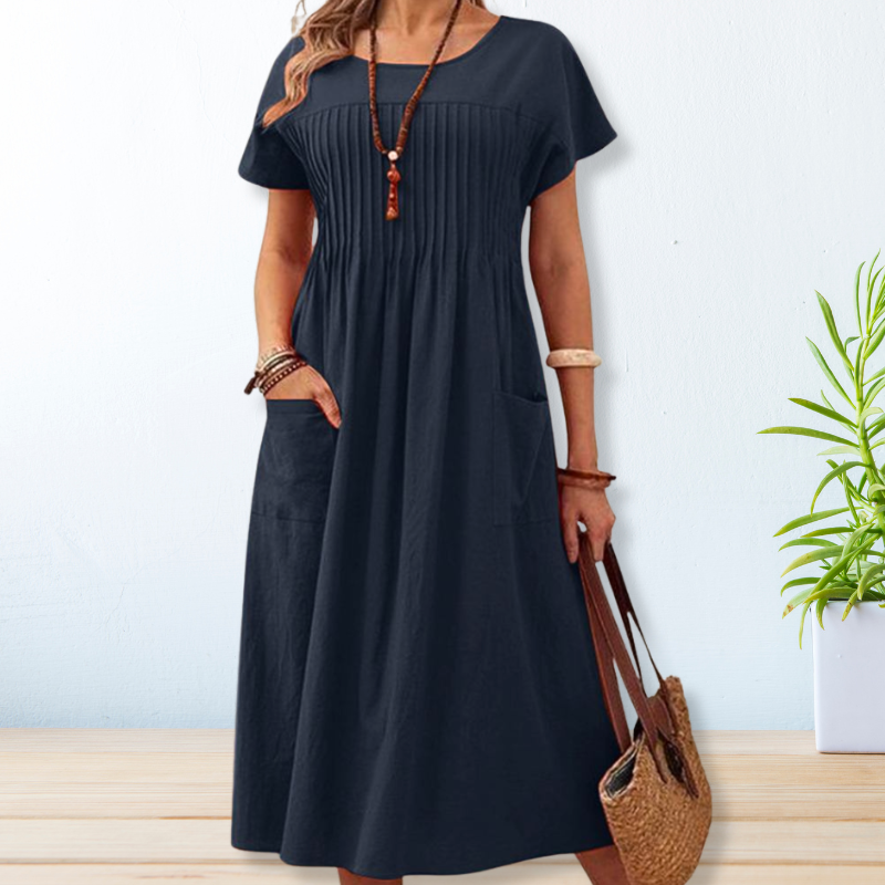Women's relaxed fit midi dress with short sleeves and convenient pockets, perfect for comfortable everyday wear.
