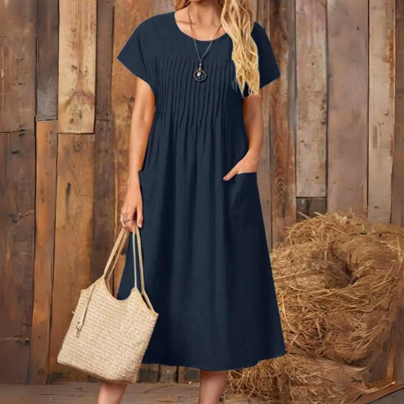 Short sleeve women's midi dress featuring a relaxed fit and handy pockets, great for casual, comfortable everyday wear.
