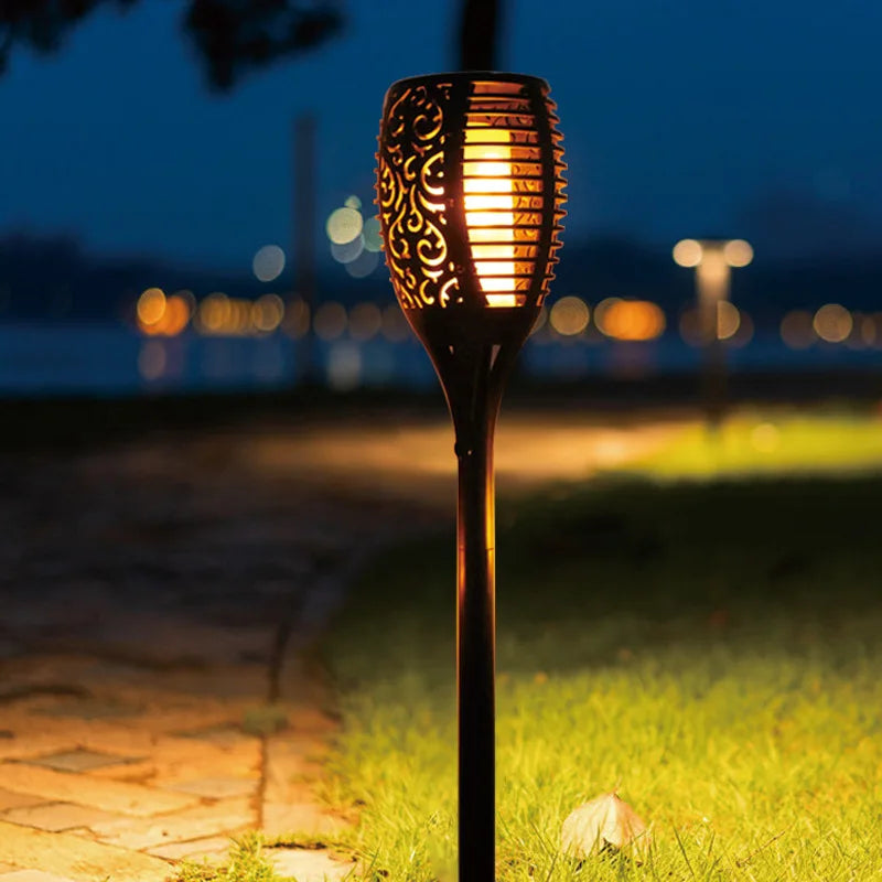 Outdoor solar torch providing enchanting flickering LED flame effect for garden and yard decor.