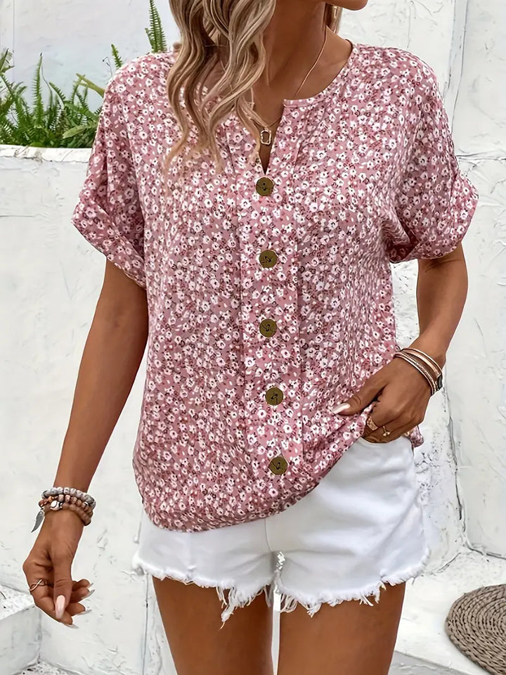 Women's vibrant floral print blouse with delicate button detailing, a chic and comfortable summer top.