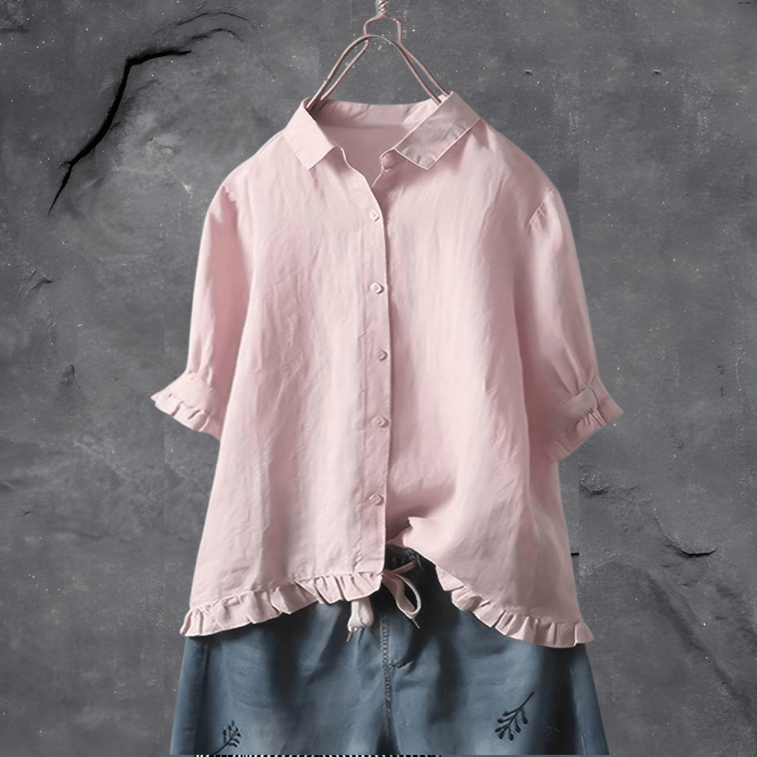 Model wears a women's casual everyday blouse paired with jeans for an effortless, chic look.