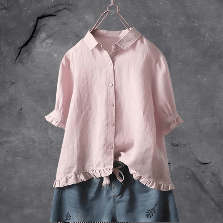 Model wears a women's casual everyday blouse paired with jeans for an effortless, chic look.