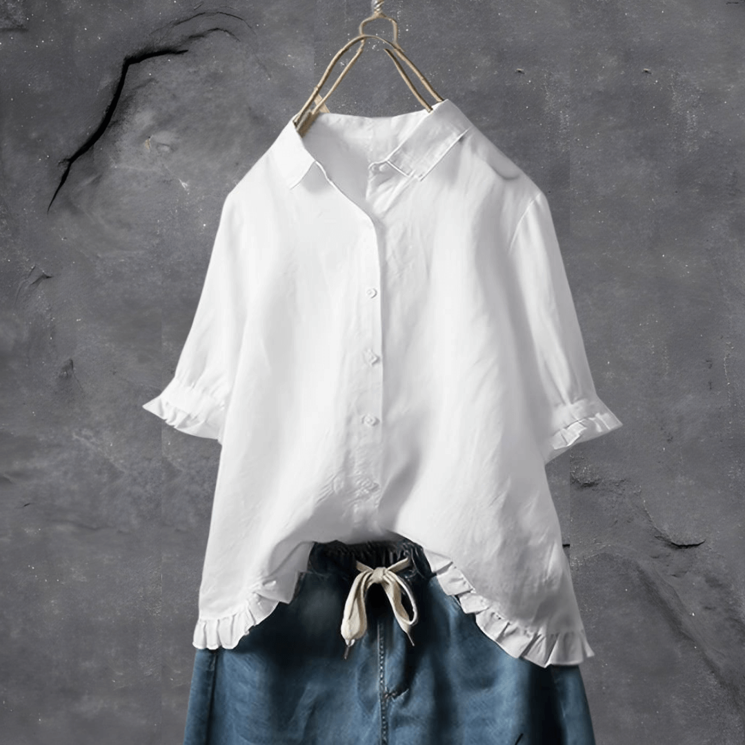 Close-up of a women's elegant white everyday blouse, showcasing soft fabric and a stylish collar detail.