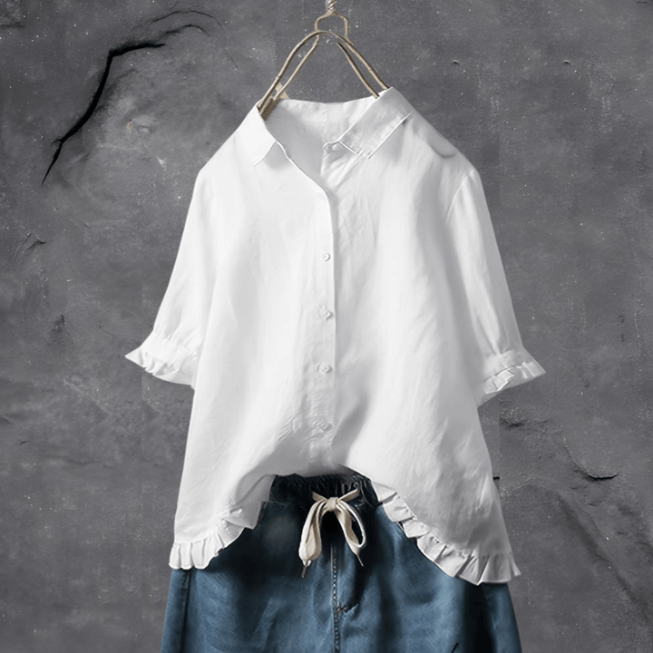 Close-up of a women's elegant white everyday blouse, showcasing soft fabric and a stylish collar detail.
