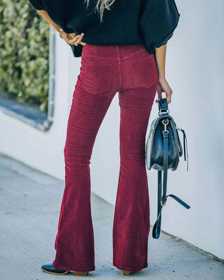 Detail of women's high-waist flare trousers, showing practical pockets and retro autumn style.