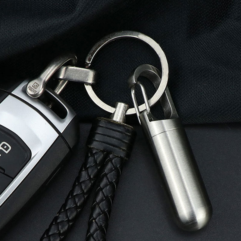 Sleek stainless steel waterproof pill box, a compact daily medication organizer with keychain.