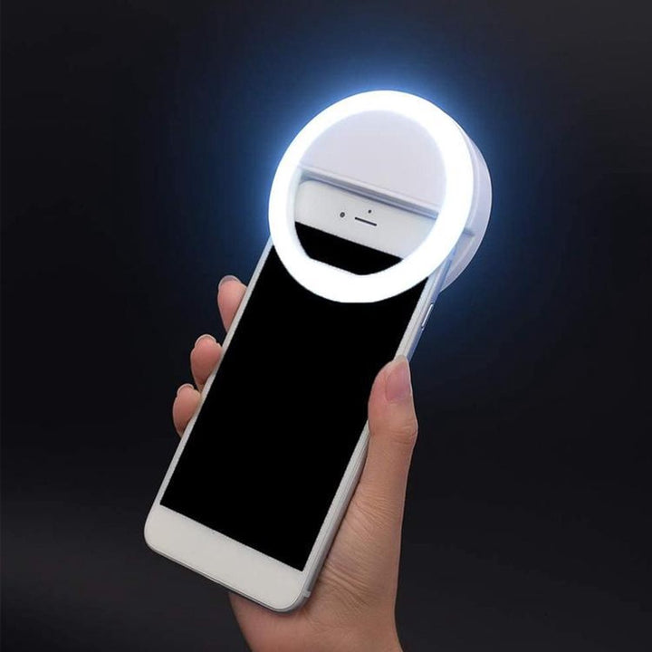Portable clip-on LED selfie ring light for phones, enhancing video and photography.