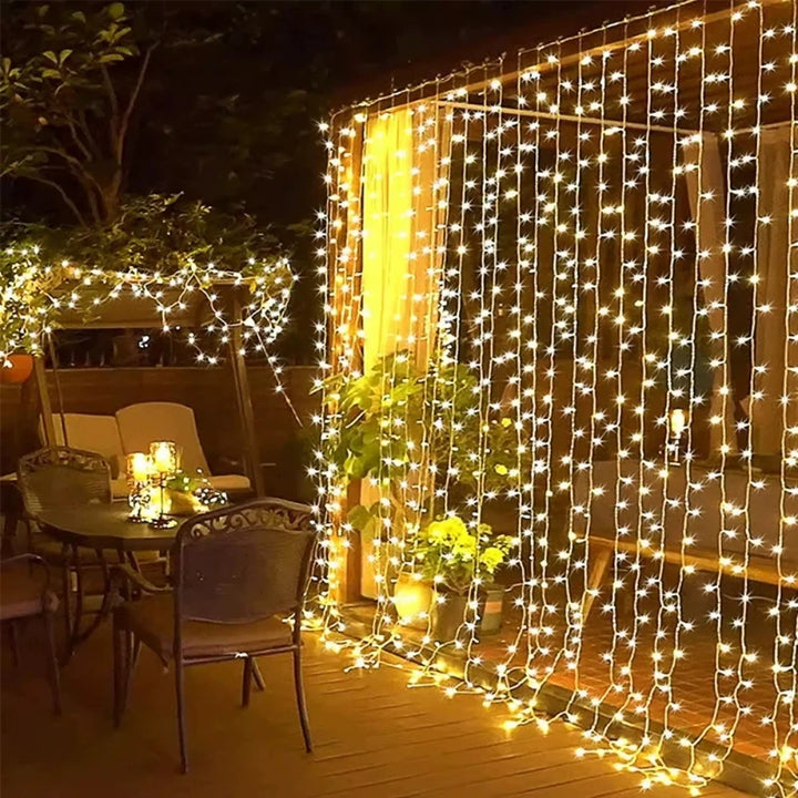 Waterproof warm white LED string curtain lights for beautiful outdoor patio or garden decor.