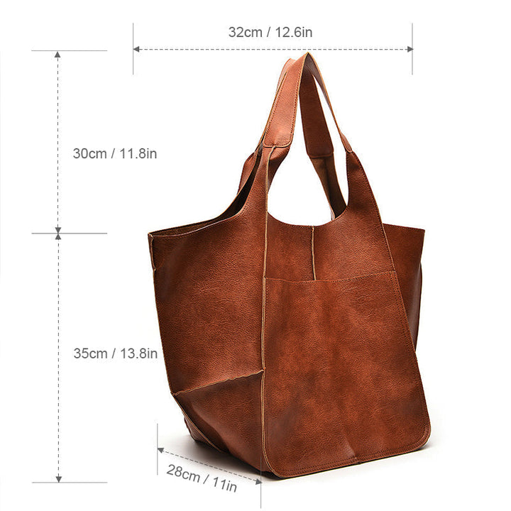 Detail of high-quality zipper on women's luxurious leather weekender travel bag.