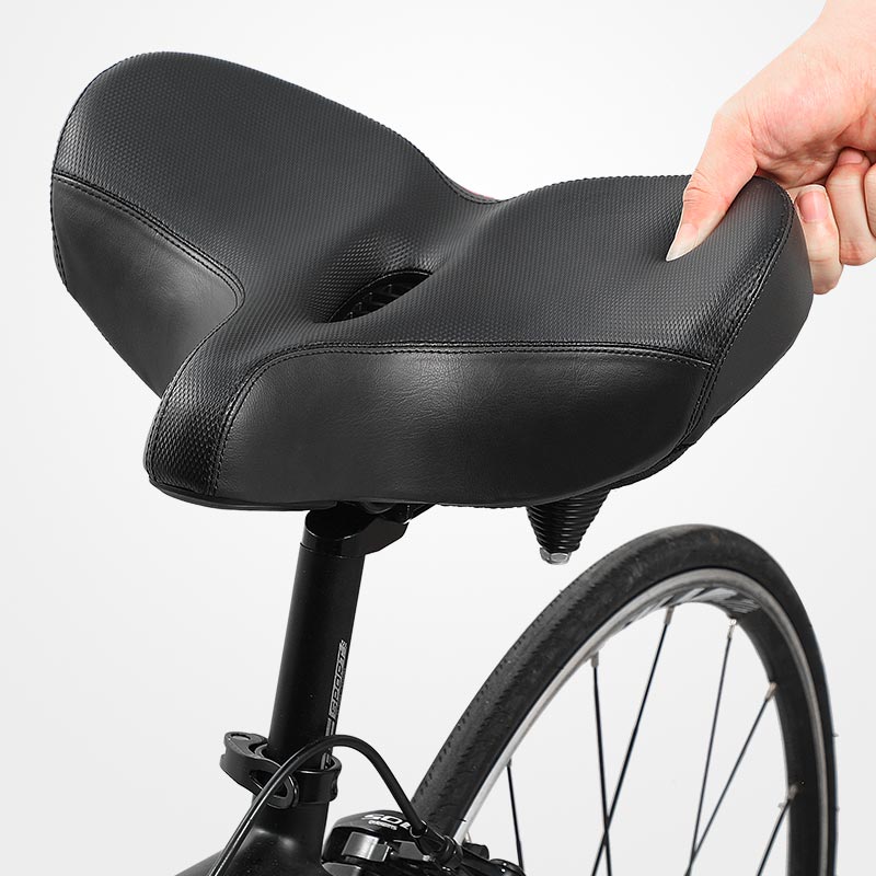 Black bicycle saddle with ergonomic design & thick padding for superior comfort and shock absorption.