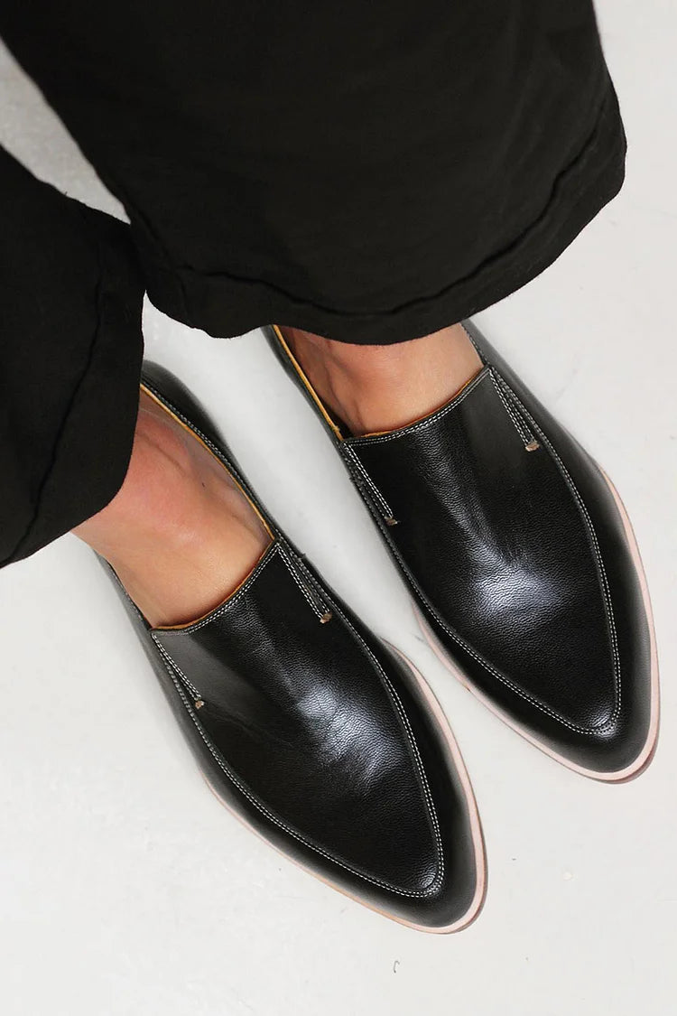 Elegant black minimalist women's loafers. Comfortable slip-on footwear, perfect for office or casual chic everyday wear.