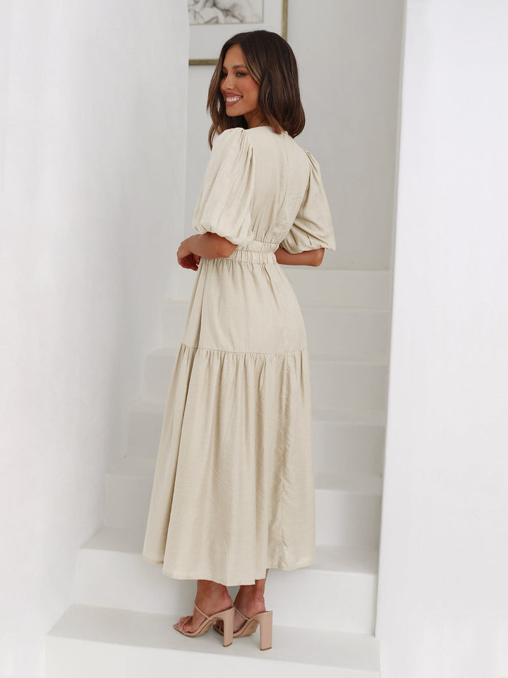 Graceful women's elegant midi dress, featuring charming puff sleeves for feminine summer style.