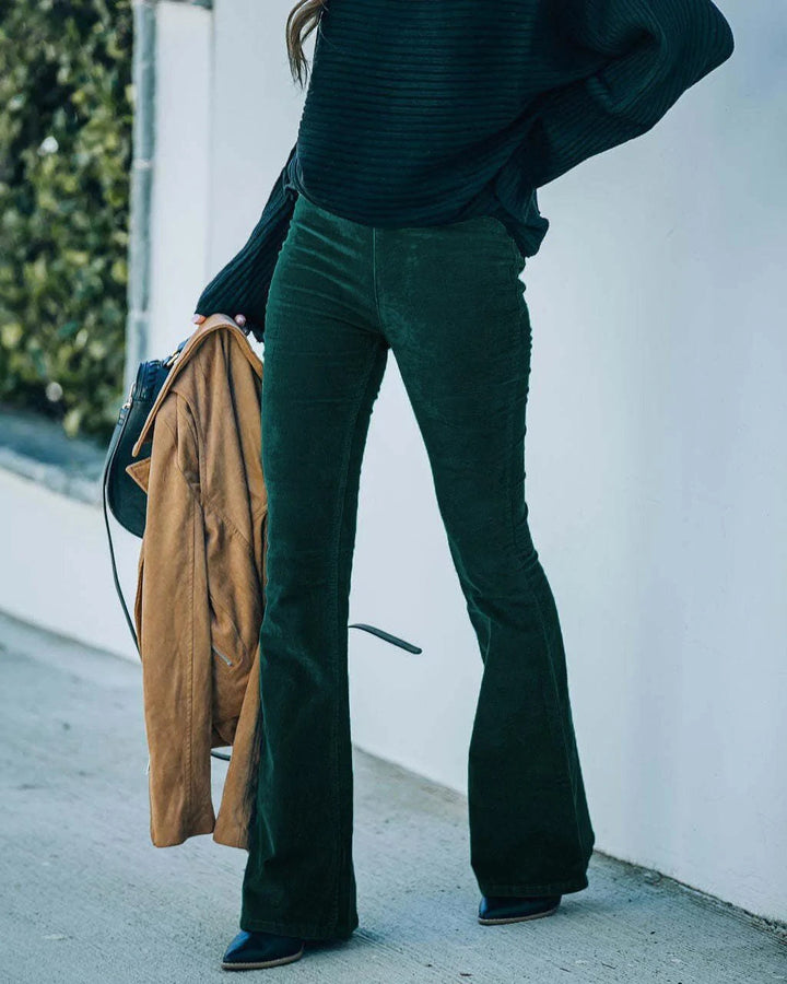 Model wears versatile women's high-waist flare trousers, perfect for retro casual everyday style.