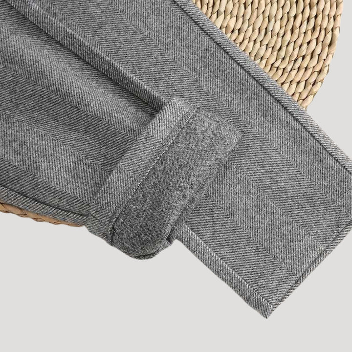 Detailed view of men's modern ankle-length tailored trousers. Showing fabric & design for office/casual wear.