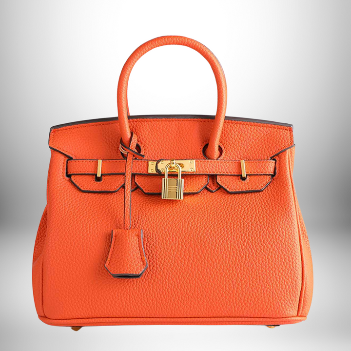 Designer women's handbag, embossed pattern, genuine leather, and polished gold hardware.
