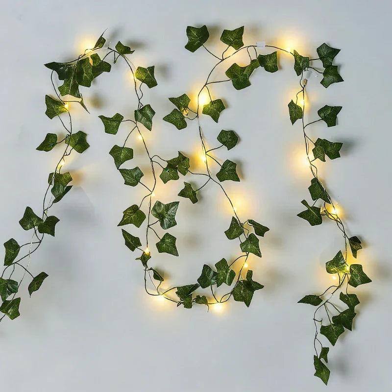 Outdoor-friendly LED vine lights, warm white, with realistic leaves for garden ambiance.