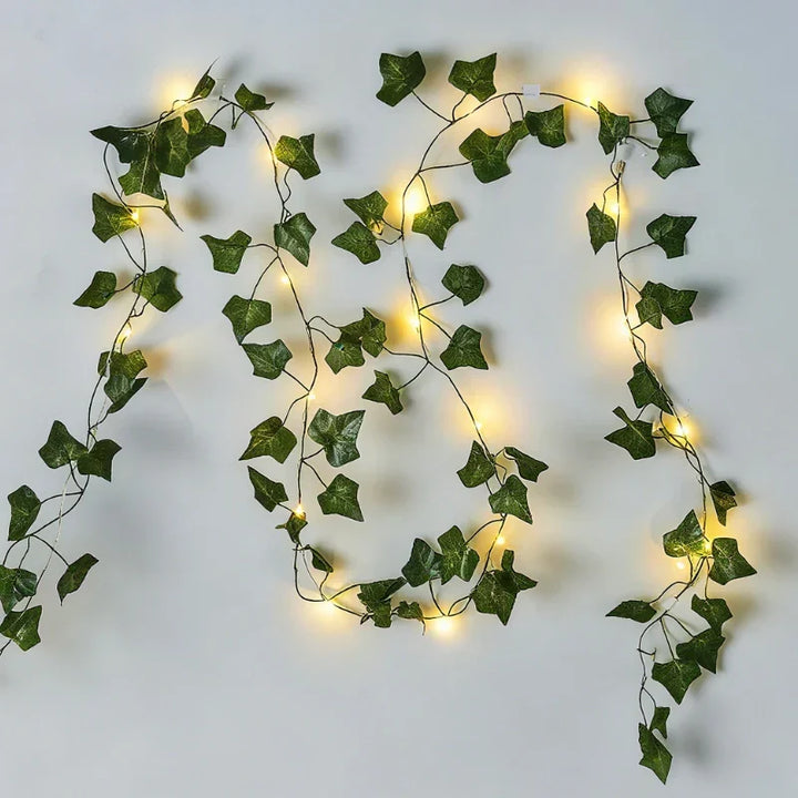 Outdoor-friendly LED vine lights, warm white, with realistic leaves for garden ambiance.