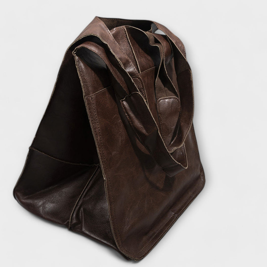 Spacious women's carryall leather shoulder bag, perfect for stylish travel & short trips.