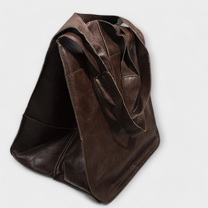 Spacious women's carryall leather shoulder bag, perfect for stylish travel & short trips.