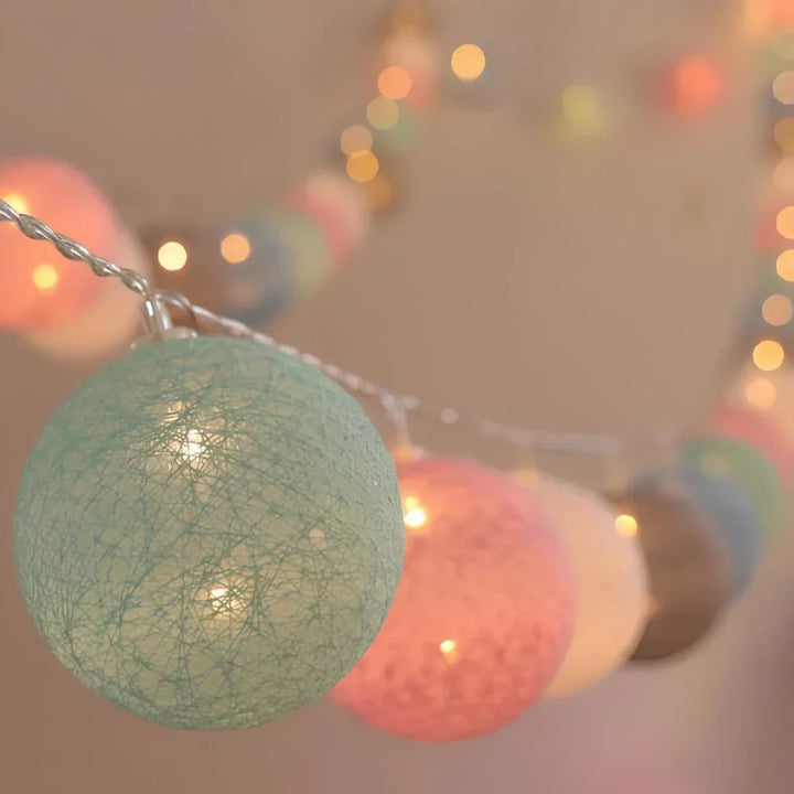 Elegant cotton ball string lights, offering soft illumination for cozy home decor.