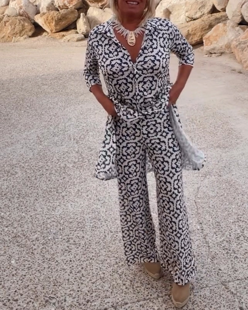 Stylish women's printed two-piece set featuring a V-neck tunic top & flowy wide-leg pants.