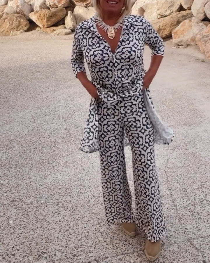 Stylish women's printed two-piece set featuring a V-neck tunic top & flowy wide-leg pants.