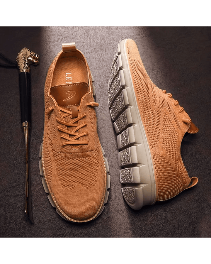 Close-up of laces and breathable mesh on men's modern everyday sneakers.