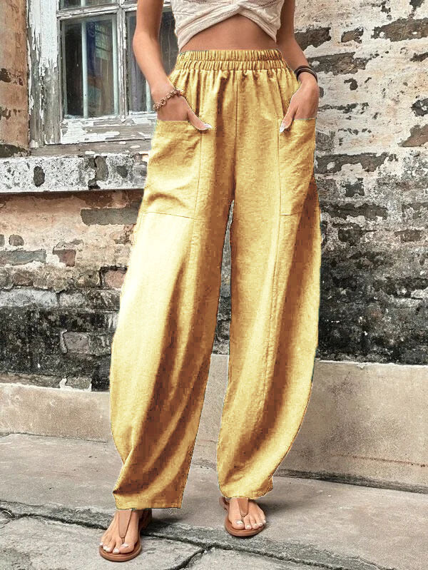 Elegant wide-leg palazzo trousers with pockets, shown on a woman, perfect for stylish versatile fashion.