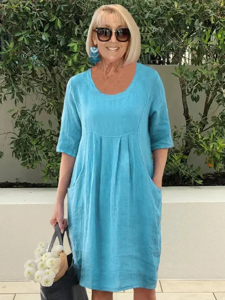 Comfortable women's loose fit midi dress, perfect for everyday fashion, featuring convenient pockets.