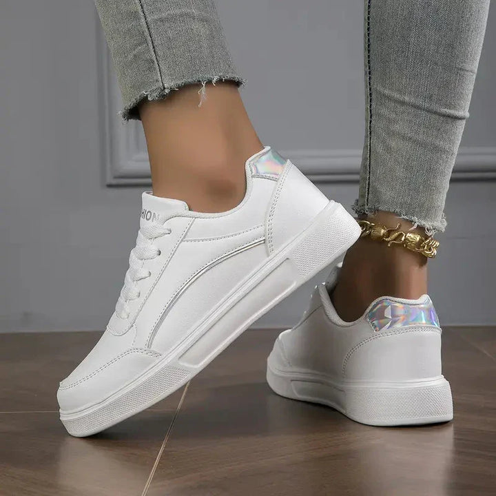 Modern women's low-cut fashion sneakers, versatile silver-gray, with stylish details. Comfortable casual footwear.