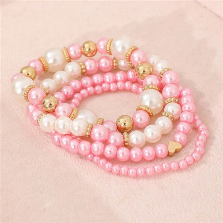 Faux pearl heart beaded bracelet set for women. White elegant layered jewelry, a perfect fashion accessory.