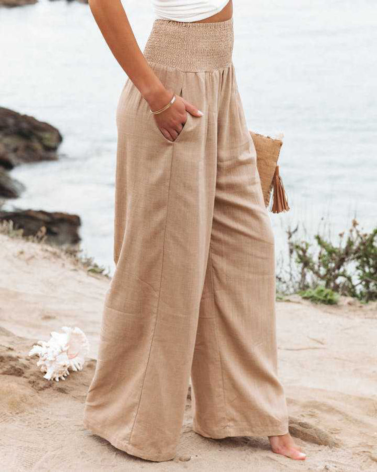 Breathable women's wide-leg linen pants with elastic waist, offering a comfortable loose fit.