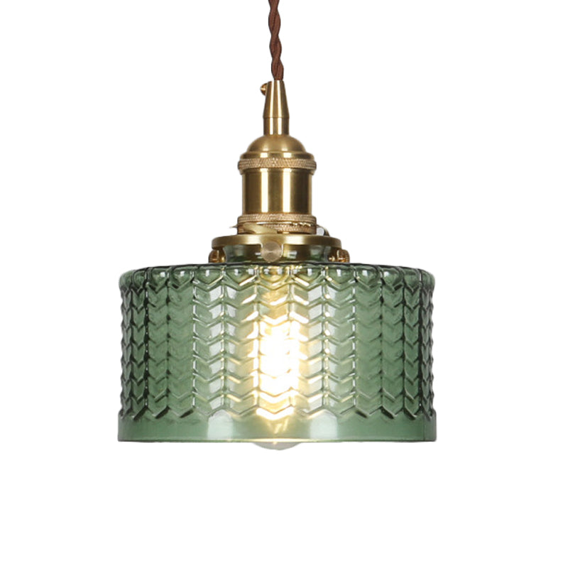 Mid-century modern ribbed glass pendant lamp with brass accents. Decorative hanging light in clear or green options.